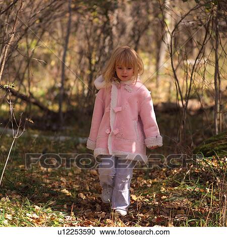 4 year old in a pink coat walking through the forest View Large Photo Image Stock Image - 4 year old in a pink coat walking through the forest. Fotosearch
