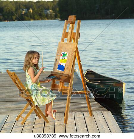 6 year old sitting at an easel View Large Photo Image Stock Photo - 6 year old sitting at an easel. Fotosearch