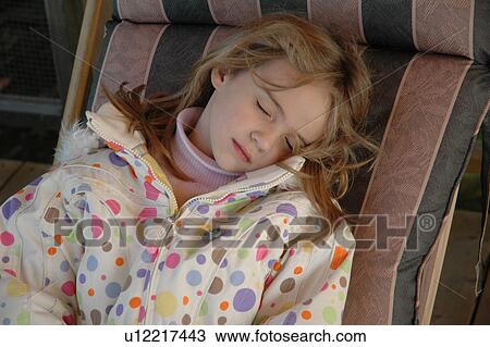 Stock Image - Girl Asleep in Deck Chair. Fotosearch