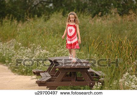 Girl Walking on Picnic Table View Large Photo Image Stock Photo - Girl Walking on Picnic Table. Fotosearch