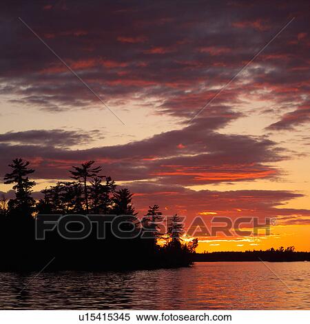 Stock Photography - Sunset on Lake of the woods, Ontario, Canada. Fotosearch