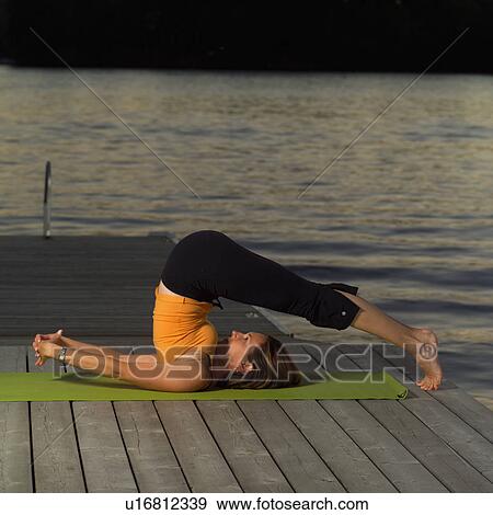 Stock Photo - Adult female doing yoga. Fotosearch
