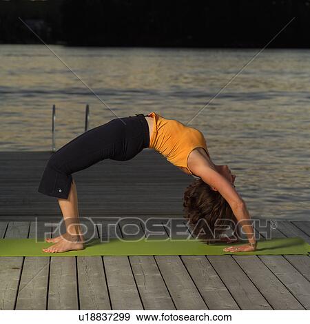 Stock Photo - Adult female doing yoga. Fotosearch