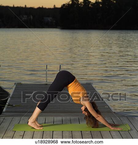 Stock Photo - Adult female doing yoga. Fotosearch