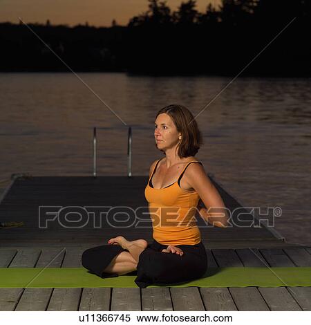 Stock Photography - Adult female doing yoga. Fotosearch