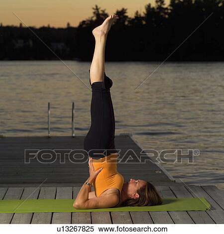Stock Photography - Adult female doing yoga. Fotosearch