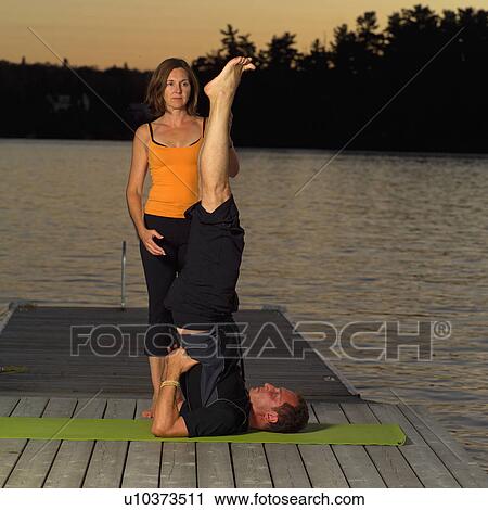 Adult male and female doing yoga View Large Photo Image Stock Image - Adult male and female doing yoga. Fotosearch