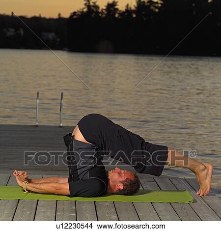 Picture - Adult male doing yoga. Fotosearch