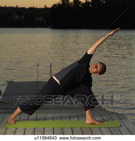 Stock Image - Adult male doing yoga. Fotosearch