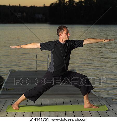 Stock Image - Adult male doing yoga. Fotosearch