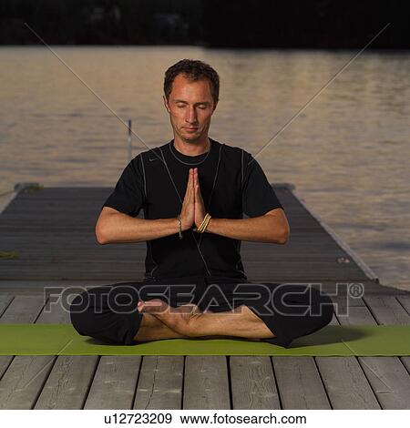 Stock Photo - Adult male doing yoga. Fotosearch