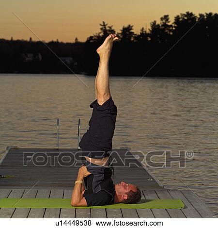 Stock Photo - Adult male doing yoga. Fotosearch