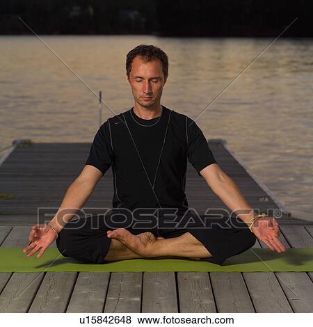 Stock Photo - Adult male doing yoga. Fotosearch
