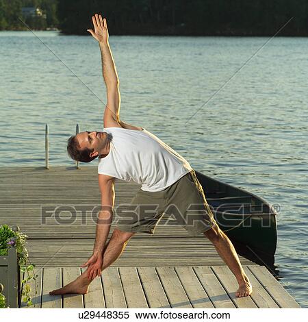Stock Photography - Adult male doing yoga. Fotosearch
