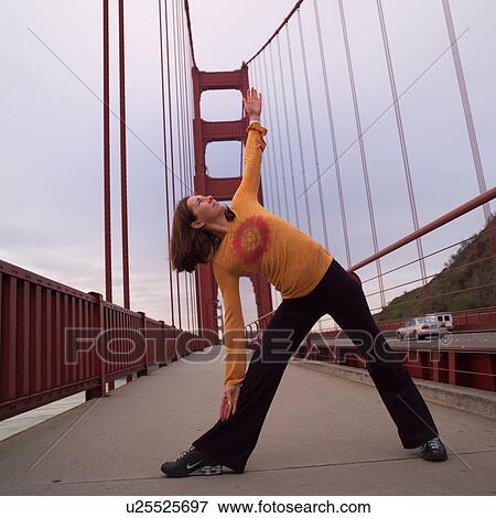 Stock Photo - Golden Gate Bridge with woman doing yoga. Fotosearch