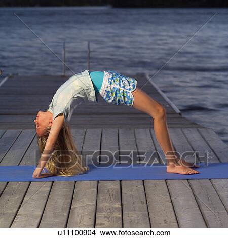 Teenage girl doing yoga View Large Photo Image Picture - Teenage girl doing yoga. Fotosearch