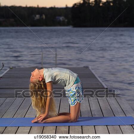 Stock Image - Teenage girl doing yoga. Fotosearch