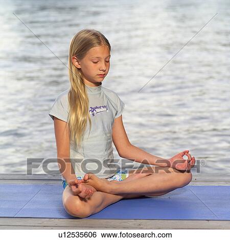 Stock Photograph - Teenage girl doing yoga. Fotosearch