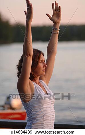 Stock Photo - Woman outdoors doing yoga. Fotosearch