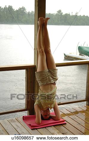 Stock Photo - Woman standing on her head. Fotosearch