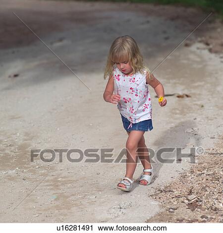 Blond Child Walking Holding Flower View Large Photo Image Stock Image - Blond Child Walking Holding Flower. Fotosearch