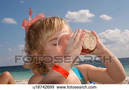 Stock Photo - Girl Drinking out of a Cup. Fotosearch