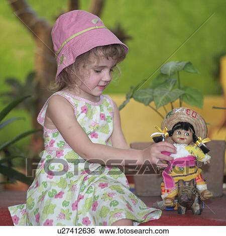Stock Photograph - Girl Playing with Doll. Fotosearch