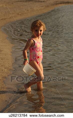Picture - Kids playing on beach. Fotosearch