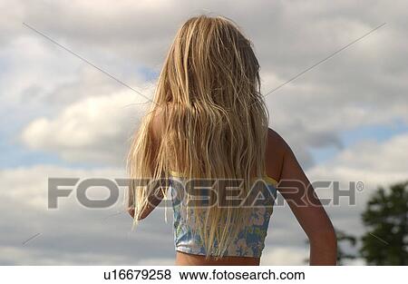 Stock Photo - Rear view of a young girl wearing a bikini. Fotosearch