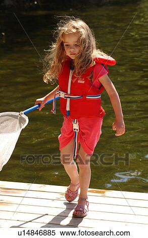 Stock Photography - Young girl holding a net running. Fotosearch