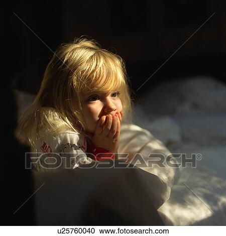 Young girl holding her mouth in apprehension View Large Photo Image Stock Image - Young girl holding her mouth in apprehension. Fotosearch