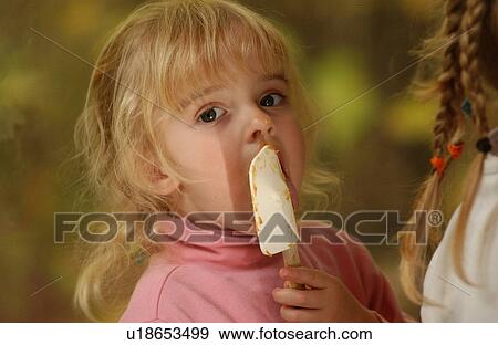 Stock Photo - Blond Girl Licking Spatula. Fotosearch