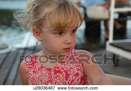 Stock Photo - Close-up of a young girl (6-8) on a boat. Fotosearch