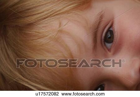 Close-up of a young girl looking at camera View Large Photo Image Stock Image - Close-up of a young girl looking at camera. Fotosearch