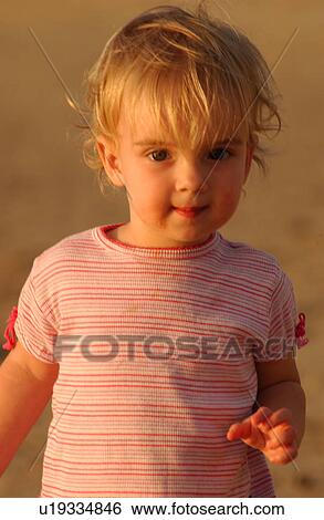 Stock Photograph - Kids playing on beach. Fotosearch