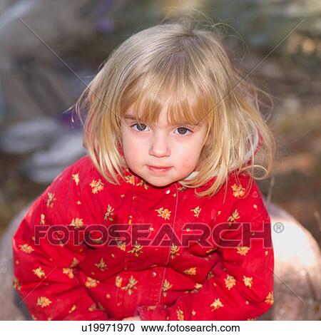 Stock Image - Portrait of a young girl looking at camera. Fotosearch