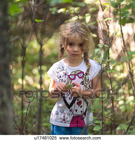 Portrait of a young girl standing in the wilderness View Large Photo Image Stock Photography - Portrait of a young girl standing in the wilderness. Fotosearch