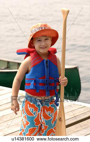 Stock Image - Small child holding an oar. Fotosearch