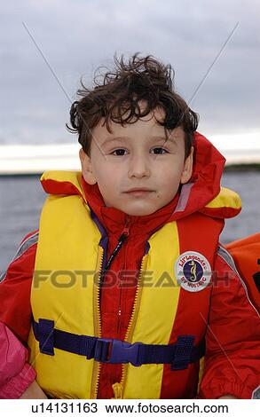 Stock Image - Young boy wearing a life vest. Fotosearch