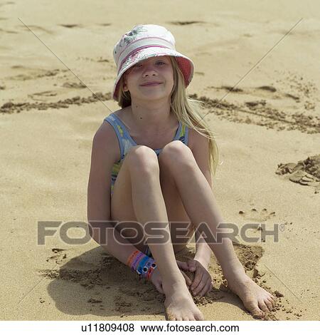 Stock Photo - Young Girl in Hat on Beach. Fotosearch
