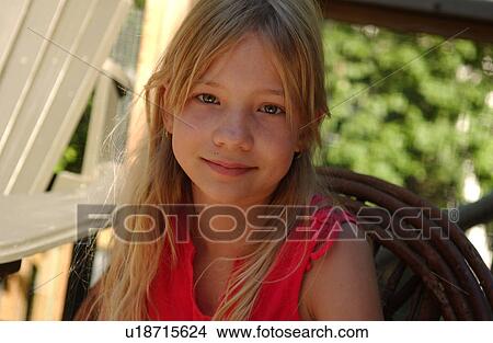 Young girl looking at camera grinning View Large Photo Image Picture - Young girl looking at camera grinning. Fotosearch