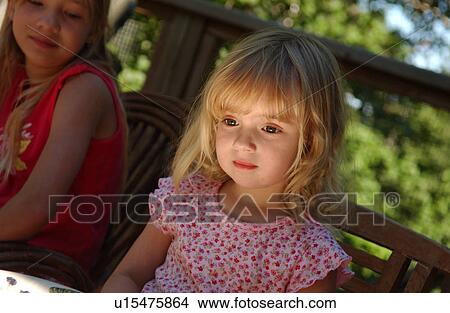 Young girl sitting looking down View Large Photo Image Picture - Young girl sitting looking down. Fotosearch