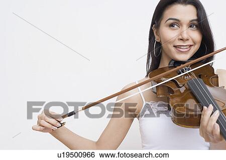 Close-up of a young woman playing a violin and smiling View Large Photo Image Stock Photograph - Close-up of a young woman playing a violin and smiling. Fotosearch
