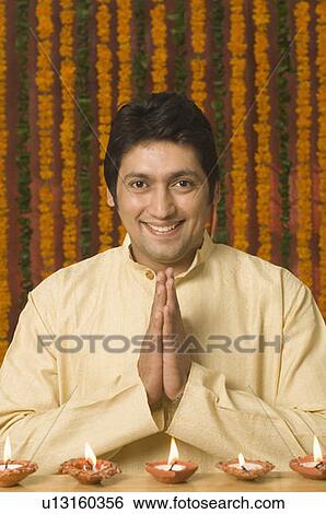 Stock Photograph - Portrait of a mid adult man greeting. Fotosearch