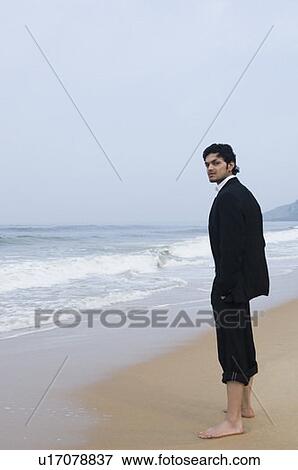 Side profile of a businessman standing on the beach View Large Photo Image Stock Photo - Side profile of a businessman standing on the beach. Fotosearch