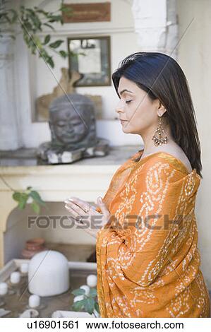 Mid adult woman praying in front of Lord Shiva View Large Photo Image Stock Image - Mid adult woman praying in front of Lord Shiva. Fotosearch