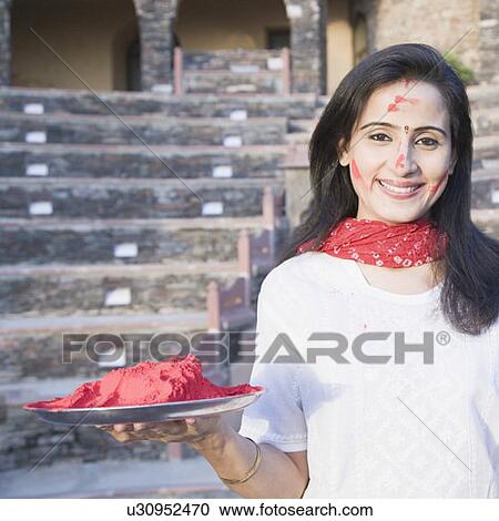 Portrait of a mid adult woman holding a plate of powder paint, Neemrana Fort Palace, Neemrana, Alwar, Rajasthan, India View Large Photo Image Stock Image - Portrait of a mid adult woman holding a plate of powder paint, Neemrana Fort Palace, Neemrana, Alwar, Rajasthan, India. Fotosearch
