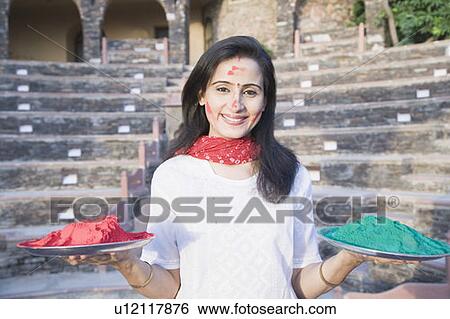 Portrait of a mid adult woman holding plates of powder paint, Neemrana Fort Palace, Neemrana, Alwar, Rajasthan, India View Large Photo Image Stock Photograph - Portrait of a mid adult woman holding plates of powder paint, Neemrana Fort Palace, Neemrana, Alwar, Rajasthan, India. Fotosearch