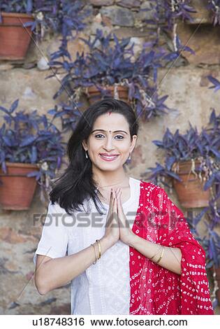 Portrait of a mid adult woman standing in a prayer position View Large Photo Image Stock Photograph - Portrait of a mid adult woman standing in a prayer position. Fotosearch