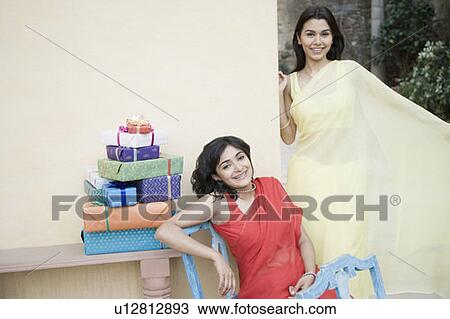 Stock Image - Portrait of two young women smiling. Fotosearch